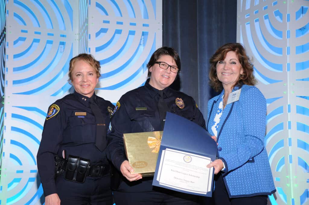 Senior Detective Tracey Barr awarded Rita Olson Legacy Scholarship by SDPD Assistant Chief Sandra Albrektsen and SDG&E representative Pat Rose, the Director of Corporate Security at Sempra Energy, at the 2023 Women in Blue luncheon. 