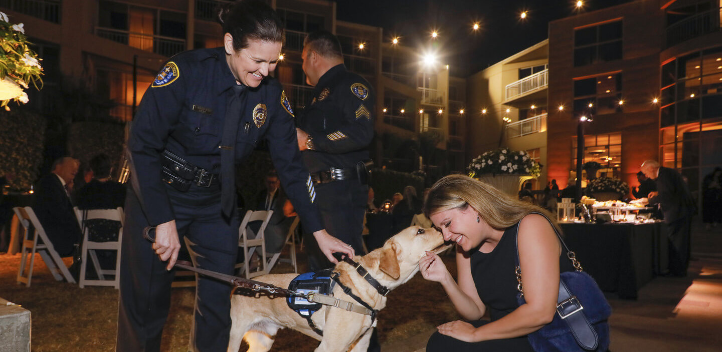 Woman petting a police dog at an event